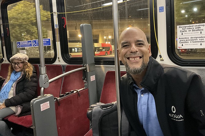 Izzy grins as Lupita sings, aboard the therapeutic #35 bus