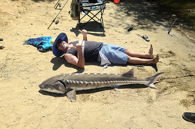 Jeremy Mitchley with his massive white sturgeon caught at Lake Cuyamaca.