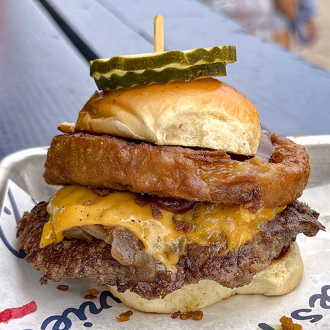American cheese, onion confit, kewpie mayo, and a quarter pound of smashed wagyu beef on a slider-sized bun