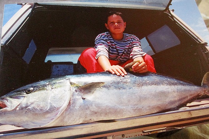 Local youngster with Paul Camacho’s 58-pound yellowtail caught from shore in Bahia Asuncion.