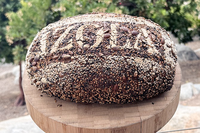 An Izola branded loaf of seedy multigrain sourdough