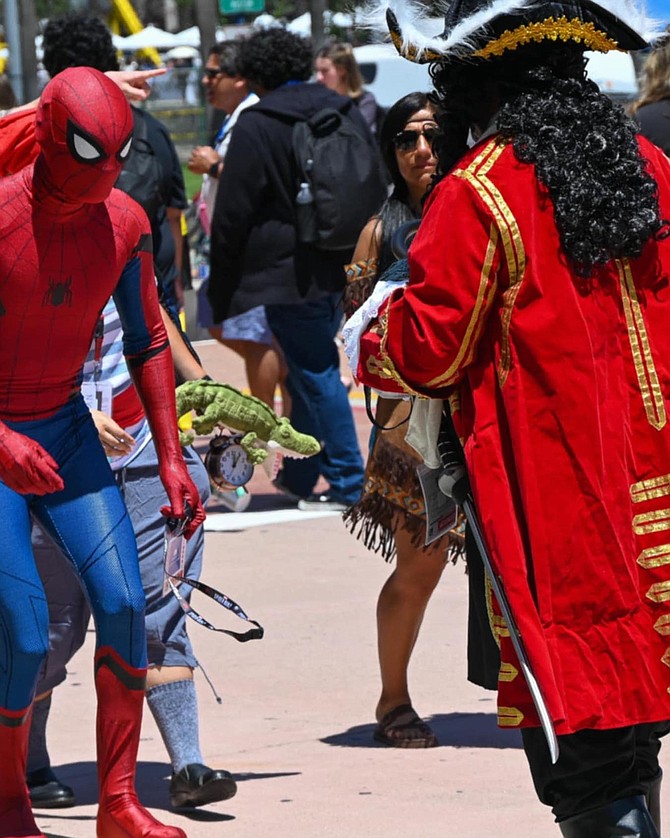 "They stand in front of our booth taking selfies with all the cosplayers who pass by, and potential customers walk right past us."
