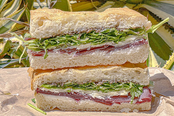 The Lucca signature sandwich: breseola, arugula, truffle paste, parmesan, and straccitella cheese on herbed focaccia bread