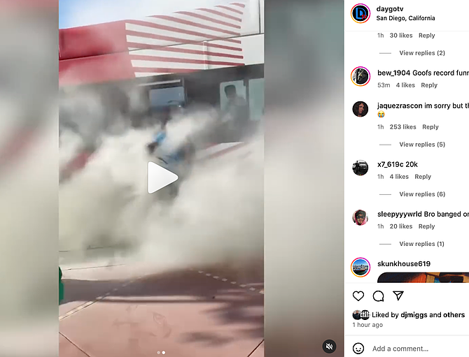 One individual is captured falling onto the sidewalk in his haste to escape the dense smoke.