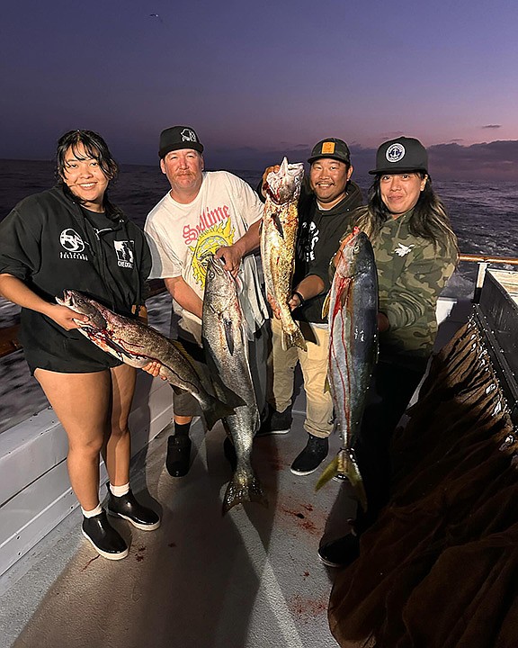 Happy anglers aboard the Daily Double score on yellowtail and white seabass during a PM half-day trip in nearshore waters.