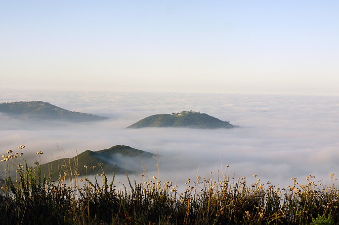 San Elijo's Double Peak mountain looks like islands in the autumn fog.