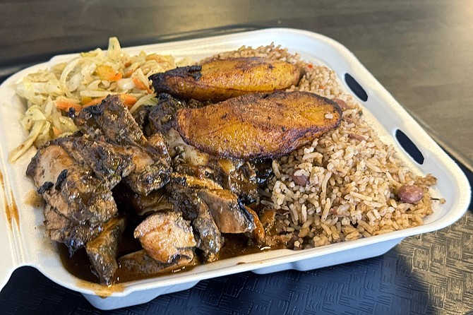 Jerk chicken with grilled plantains, rice and peas, and stewed cabbage