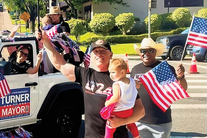 Larry, holding daughter Zoey, at this year’s Rancho Bernardo 4th of July parade. Larry’s wife Cynthia is in the jeep (wearing a hat) holding their son Zac.