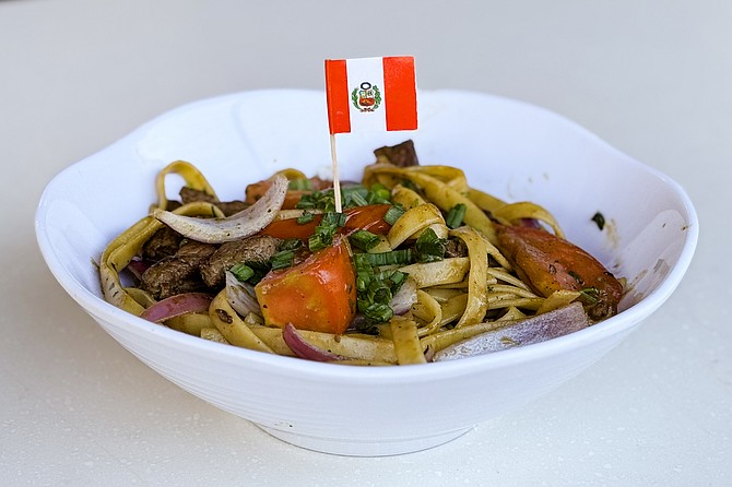 Tallarin soltado: fettucini topped with soy sauce and sirloin steak stir fry