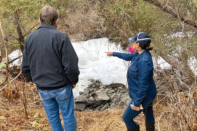 Imperial Beach Mayor Paloma Aguirre (right) showing the build-up of toxic foam in the Tijuana River to National City Mayor Ron Morrison on September 23.