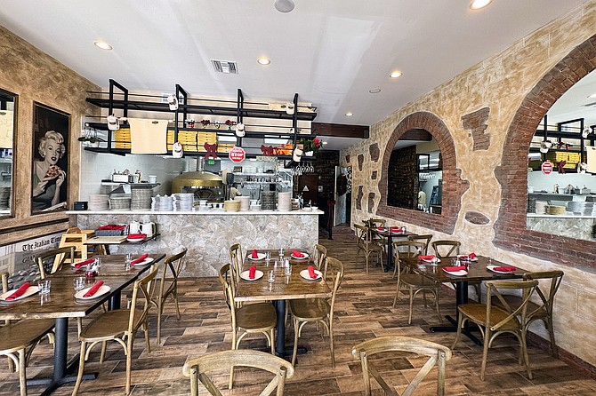 A pizza shop open next door to its Italian sister restaurant