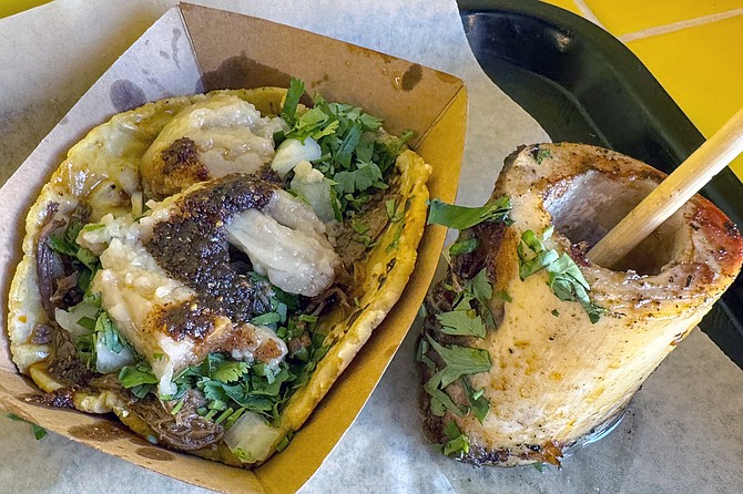 A birria taco on handmade corn tortilla with roasted marrow