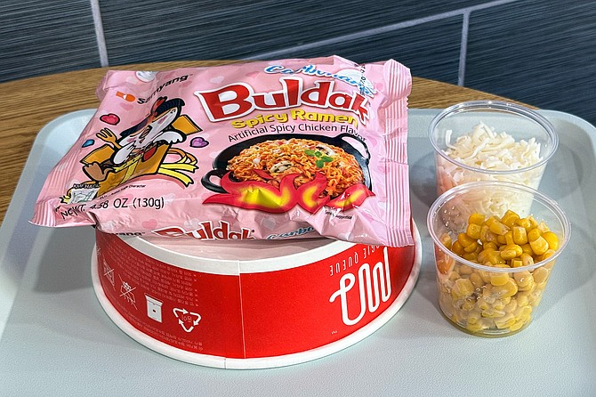 An order of ramyun, served still in its packageat the counter, with a bowl and toppings on the side