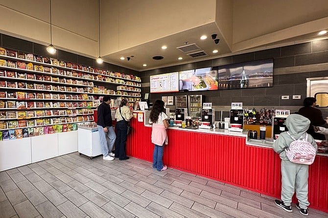 Customers make their own instant noodles, picked out from the wall of ramyun packages