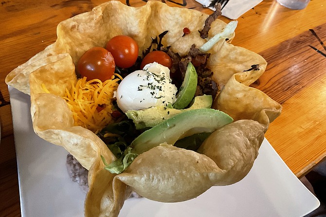 Taco salad with carne asada in an edible tortilla bowl, $15.99