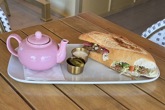 A machaca torta with a pink teapot of chipotle-tomato broth to pour over it
