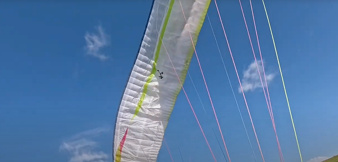 A drone unexpectedly flew into his canopy and became entangled in one of the lines.