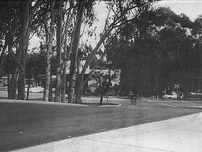 The Great Crossroads. Bikes and pedestrians abound, but autos have no place to go except around a traffic island
