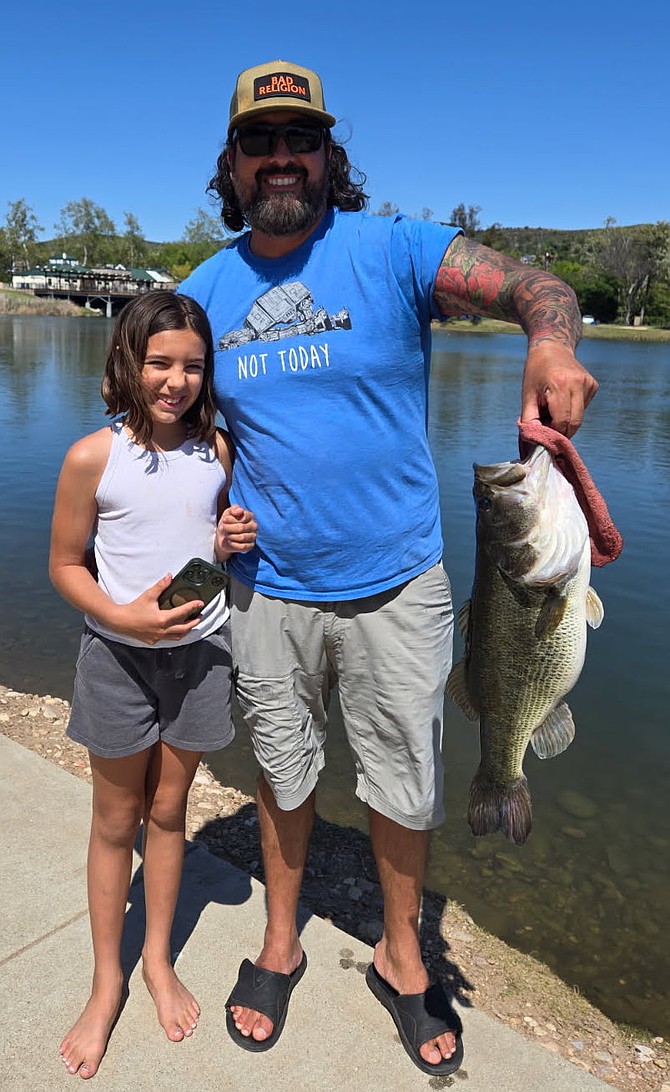 Father/daughter team with a solid largemouth bass caught out of Lake 4 on a nightcrawler. The fish was safely released.