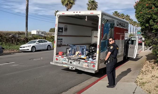 A video from Newsreel Media shows the inside of that U-Haul packed with a shopping cart and goods still tagged with price stickers.