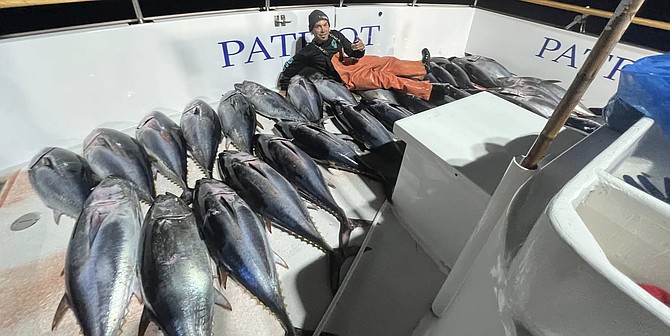 Local lure maker, tattoo artist, and deckhand Brandon Douglass Cross with some quality bluefin while working a trip aboard the Patriot.