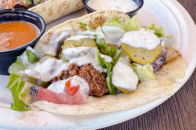 A falafel taco, topped with pickled okra, turnip, and tahini
