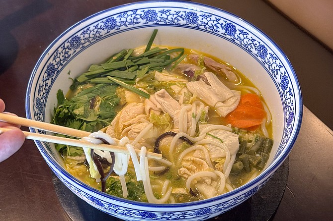 A chicken noodle soup with plenty of noodles