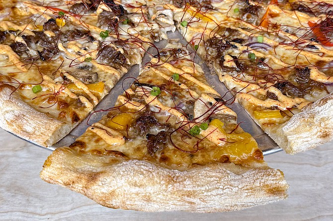 A Bulgogi Supreme pizza, topped with chili threads