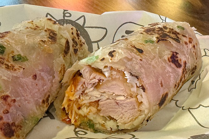 Popcorn chicken, cabbage, and cheese wrapped in a scallion pancake