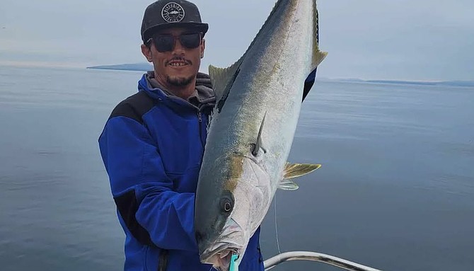 Captain Cristian Catian of K&M Sportfishing running out of San Quintin with a solid surface iron-caught yellowtail.