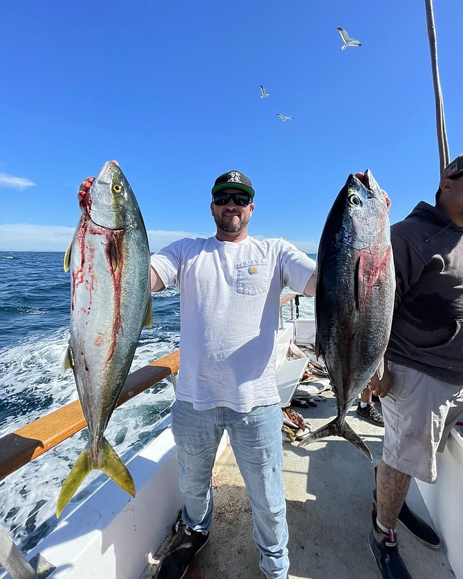 Happy angler aboard the Malihini with a yellowtail and a bluefin tuna caught near the Coronado Islands on a full-day run.