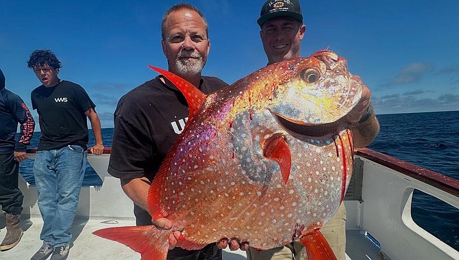 Pacifica captain Andrew Viola with angler Kevin Patch’s beautiful opah caught while dropping a jig on a 1.5-day run.