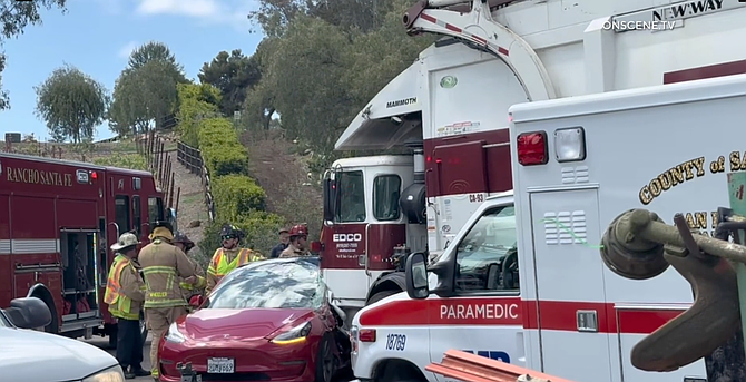 in Rancho Santa Fe, a trash truck T-boned a Tesla, trapping its driver inside.