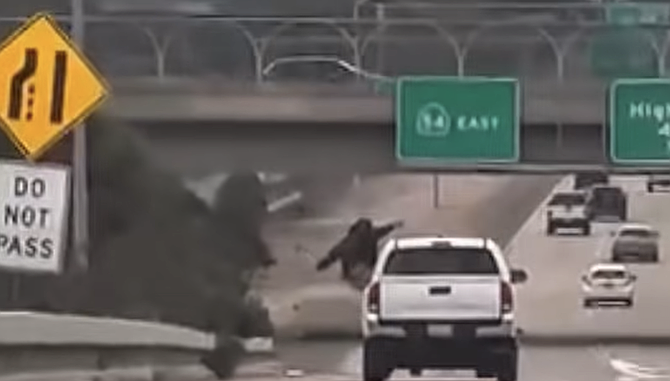 Guy climbing out of his truck window while it’s still rolling down the freeway.
