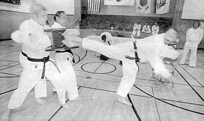Blamey breaking board at tae kwon do. “I’m glad I got cancer. Well, not twice." - Image by Sandy Huffaker, Jr.