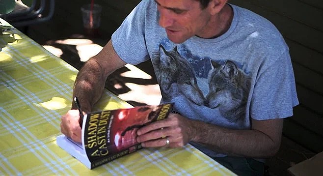 Urban fantasist Ben Johnson signs his novel, A Shadow Cast in Dust, at a 2014 event