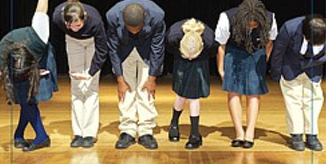 Eight hundred students dressed in tan pants, black shoes, white dress shirts buttoned to the top, and navy blue ties