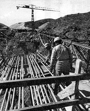 Hundred of threaded steel rods pre-stress the bridge (February '74).