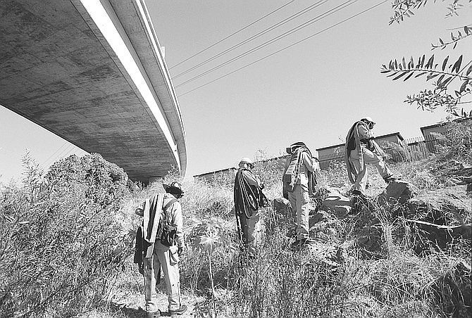 Firefighters under I-5 bridge. "Not only do the homeless fill it with debris, but the taggers leave their cans around and the paint goes into the river."