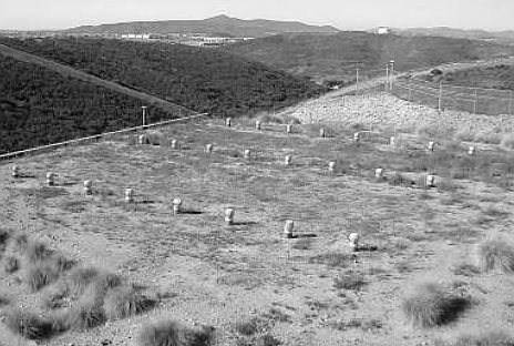 Camouflaged earth roof of the underground missile storage. Pipes are air vents.