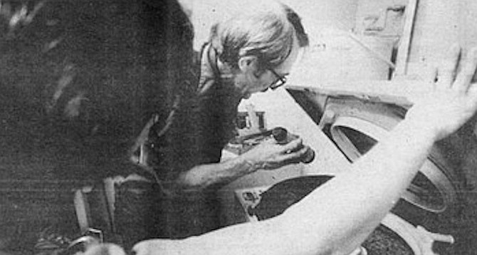 Frude breaks his own 14-minute record in removing and replacing both pump and belt. The entire job for parts and labor on two machines comes to $146.65. The woman seems to feel it is well worth it. - Image by Robert Burroughs
