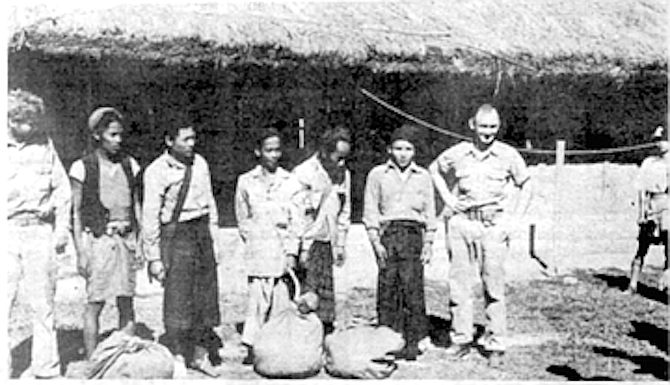 Two rescued Hump crewmen stand with their five rescuers after being forced down in India’s rugged Naga Hills.