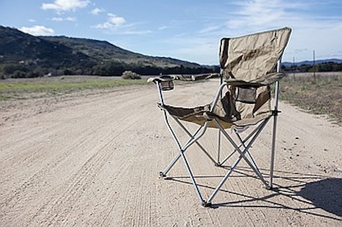 Alyce Copeland sat in a folding chair, blocking the road